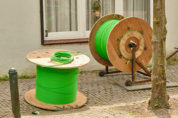 Fiber optic cable rolls and dispenser during rural installation work