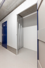 Open empty self-storage unit with a view into the clean interior