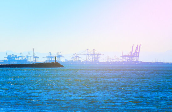 Seaport view. Container crane in seaport in La Marina de Valencia, Spain. Gantry cranes in Seaport. Shipping containers, Sea containers in port for shipping. Maritime logistics, sea ​​transportation