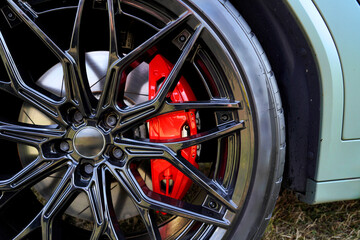 Racing brake disc and low profile tyres. Race car test driving. Lower-profile tires of drag and...
