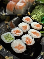 Close-up of maki rolls with salmon and cucumber. Fresh, minimalistic, and traditional Japanese sushi