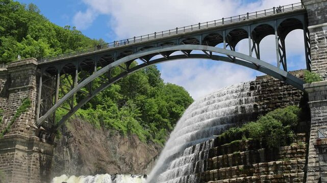 water cascading down waterfall at croton dam (man made and natural drinking water reservoir) westchester new york landmark with old bridge (tourism travel hiking destination) nature landscape