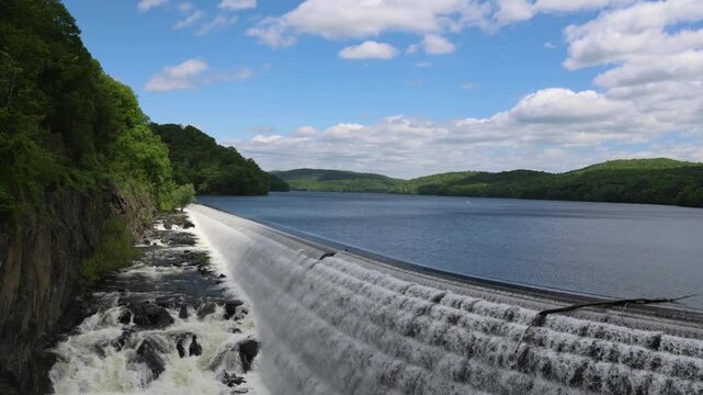 water cascading down waterfall at croton dam (man made and natural drinking water reservoir) westchester new york landmark with old bridge (tourism travel hiking destination) nature landscape