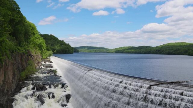 water cascading down waterfall at croton dam (man made and natural drinking water reservoir) westchester new york landmark with old bridge (tourism travel hiking destination) nature landscape