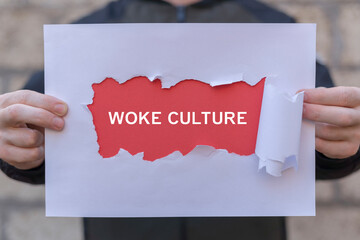 Person holding banner of paper sheets with inscription: WOKE CULTURE. Woke Culture Social Issues Political Diversity Pepole Rights concept.