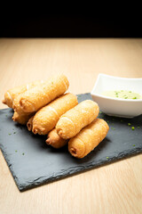 Delicious tequenos served with guasacaca sauce, a traditional venezuelan appetizer