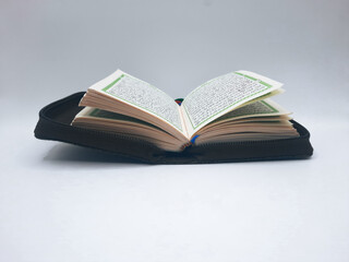 image of a sheet in a pocket al - quran on a white background 