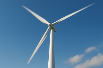 Wind turbine closeup with motion blur under clear blue sky
