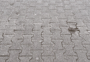 Detailed macro view of a dirty city sidewalk with visible dust, stains, and debris. Useful for themes of urban infrastructure, decay, public spaces, or environmental awareness.