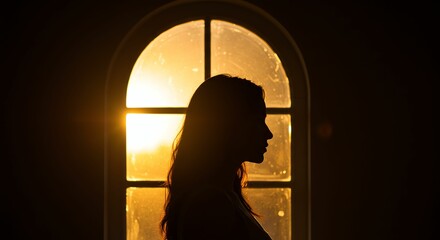 Silhouette of Woman Near Window at Sunset