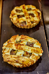 Mini pie (pastel de manzana). Freshly baked Ecuadorian pastries with golden crust and rich filling...