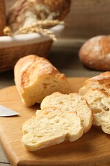 Slices of fresh bread on wooden table, closeup