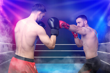 Boxers surrounded by smoke fighting in ring. Sporting event