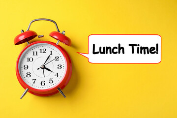 Alarm clock and speech bubble with words Lunch Time on yellow background