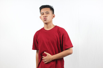 Asian man wearing red t-shirt feeling stomachache isolated on white background