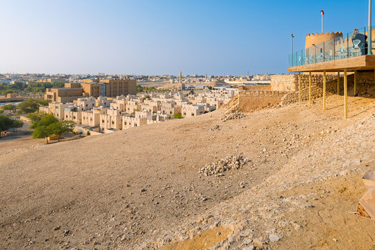 The cliffside, historic Riffa Fort also known as Shaikh Salman bin Ahmed Fateh Fort or Qal'at ar-Riffa, rises above the ancient ruins, desert and the town of Riffa, Bahrain.