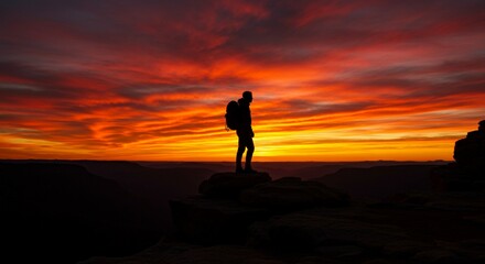 silhouette of a man standing on the top of the mountain
