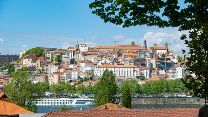 View from Vila Nova de Gaia to the city of Porto, Portugal, on a bright sunny day with blue sky.