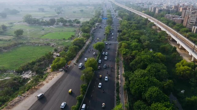 Top down cross traffic highway with cars, trucks aerial. Urban transportation at bridge road at Delhi. Cinematic cityscape of downtown freeway drone shot. Noida Freeway.