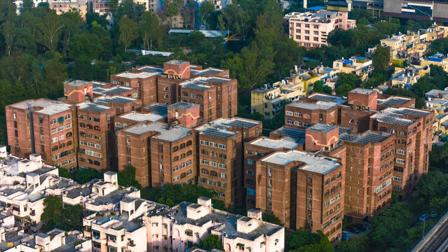 Top down Buildings and Apartment with Multiple Building aerial. Urban Buildings and Apartment at bridge road at Delhi. Cinematic cityscape drone shot. Noida Buildings.