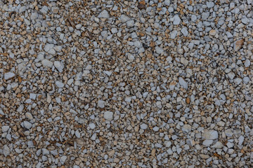 Rough, natural stone texture with earthy tones, perfect for rustic backgrounds and architectural design elements.
