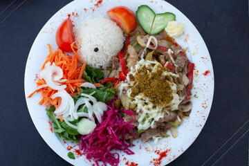 Meal of meat, mushrooms and mixed salad and rice.