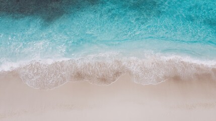 Turquoise waves meet white sand under sunlight, a serene tropical coastline blending sea and sky.
