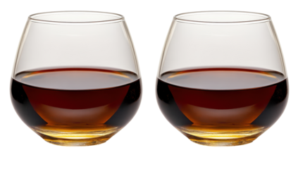Two identical, round, clear glasses filled with dark amber liquid, set against a black background