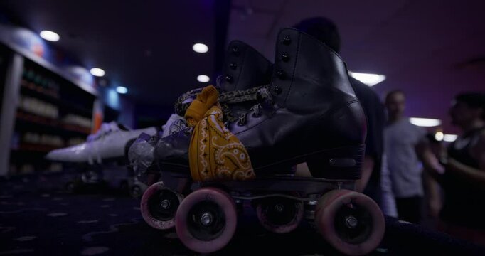 Young roller skaters grabbing their skates from desk - closeup