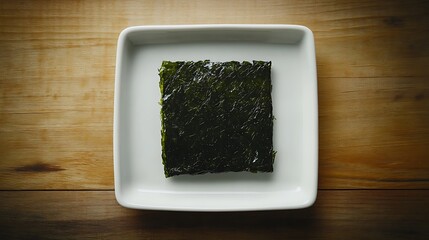 A sheet of dried seaweed on a white plate