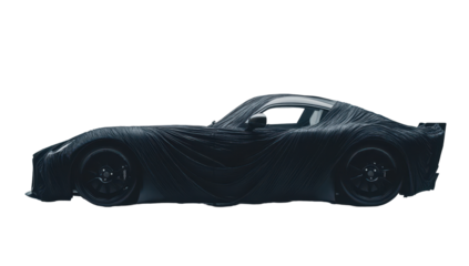 Sleek, low-slung sports car partially concealed by a dark, draped fabric, hinting at powerful, aggressive design