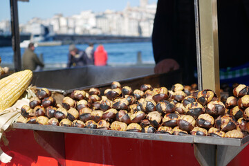 Roasted chestnuts at a waterfront market in autumn