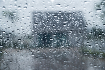 Dew drop on the car glass window during raining. Dew is the moisture that forms as a result of...