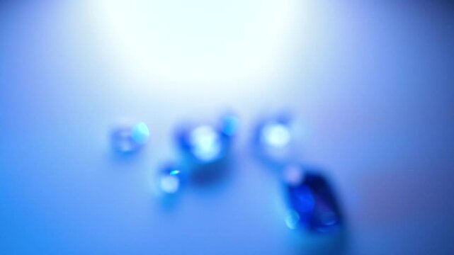 gemstones on a white table in multicolor illumination