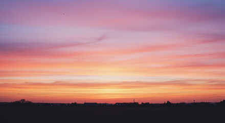 Fiery Sunrise: Red and Orange Sky with Clouds