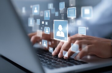 Person's hands typing on laptop, holographic user interface icons float above, depicting digital communication and networking