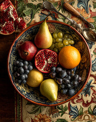 Colorful Fruit Bowl Still Life Pears, Grapes, Pomegranate and Orange