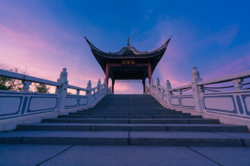 Fototapeta premium Ancient Chinese Pavilion on a Bridge at Sunrise
