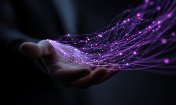 A person's open palm gently cradles a luminous, flowing stream of interconnected purple nodes and lines, suggesting data or connectivity