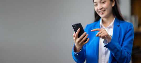 Businesswoman using mobile phone and sending messages online on smartphone.