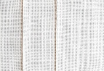 Close-up view of a white fabric with a grid pattern.
