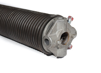 Garage door spring with spring cone winding bar. Parking gate torsion spring for overhead sectional door. Repair or installation of garage gate. Mechanical part. Selective focus. White background.