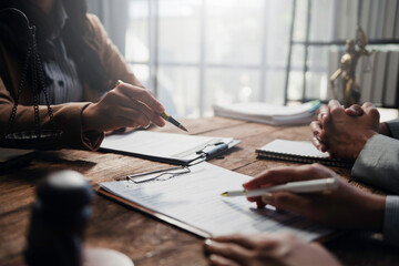 Lawyers and clients engaging in a detailed discussion about contract specifics during a focused...