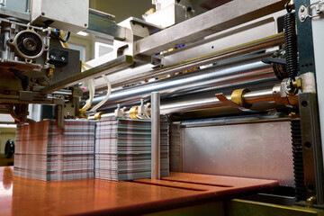 Efficient paper feed mechanism enhances productivity in glue spreading operations at modern manufacturing facility