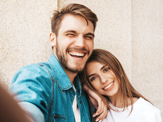 Smiling beautiful female and her handsome boyfriend in casual summer clothes. Happy family taking...