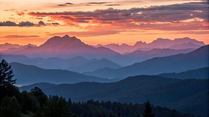 Obraz premium Golden hues cast over a tranquil mountain range at sunset, capturing the peaceful transition of day to night.