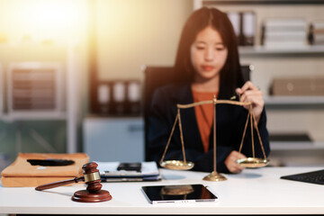 Judge gavel with Justice lawyers having team meeting at law firm background. Concepts of Law and Legal services.