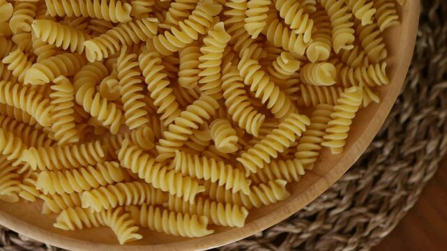 Raw Fusilli Spiral spaghetti pasta pattern background.