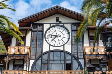 A large restaurant in Gagra. The building is decorated with a large clock visible from afar. This unusual restaurant building with a clock was brought from Scandinavia