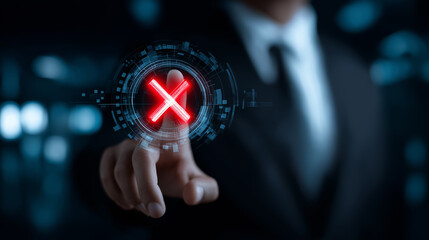 Businessman's hand touching a glowing red "X" icon on a futuristic virtual screen, symbolizing error or cancellation.
